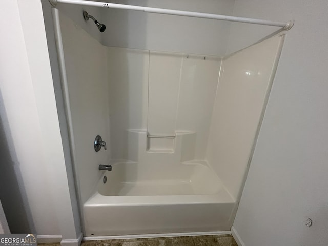 bathroom with bathing tub / shower combination