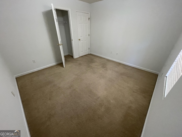 unfurnished bedroom with light colored carpet