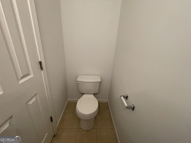 bathroom with tile patterned flooring and toilet