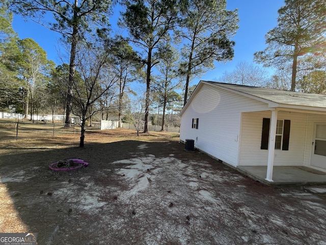 view of side of property featuring central AC and a patio area