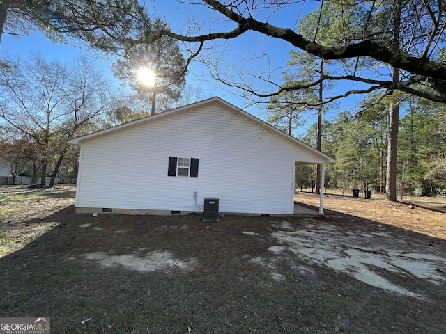 view of side of home featuring central AC unit