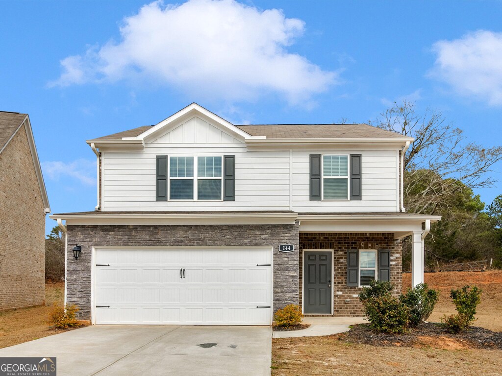 view of front of property with a garage and a porch