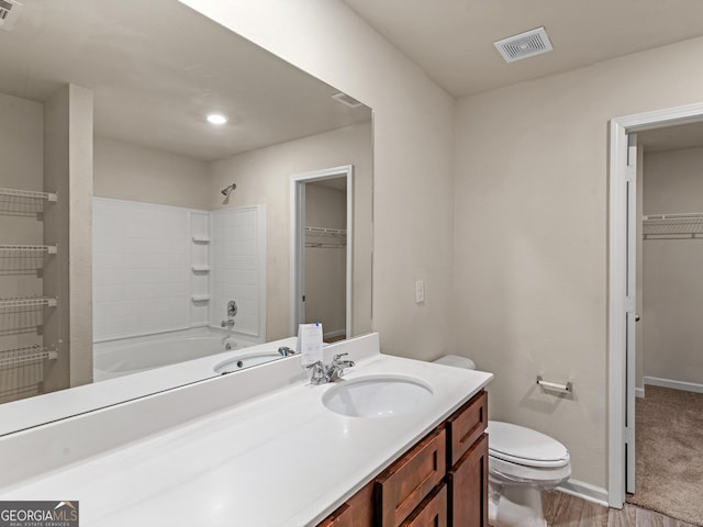 full bathroom with toilet, a spacious closet, visible vents, and baseboards