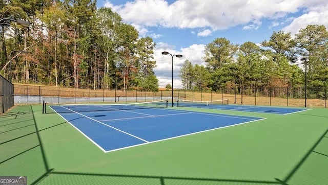 view of tennis court with fence