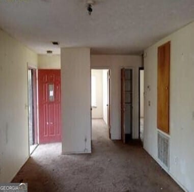 spare room with carpet and visible vents