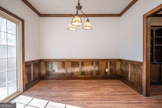 interior space featuring crown molding, a notable chandelier, and hardwood / wood-style flooring