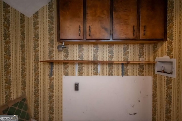 laundry room with hookup for a washing machine and cabinets