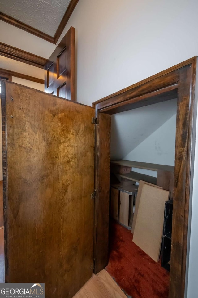 interior space with crown molding and wood-type flooring