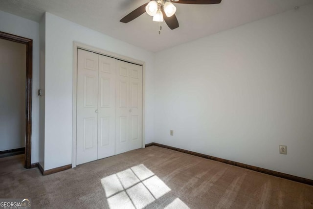 unfurnished bedroom featuring a closet, ceiling fan, and carpet flooring