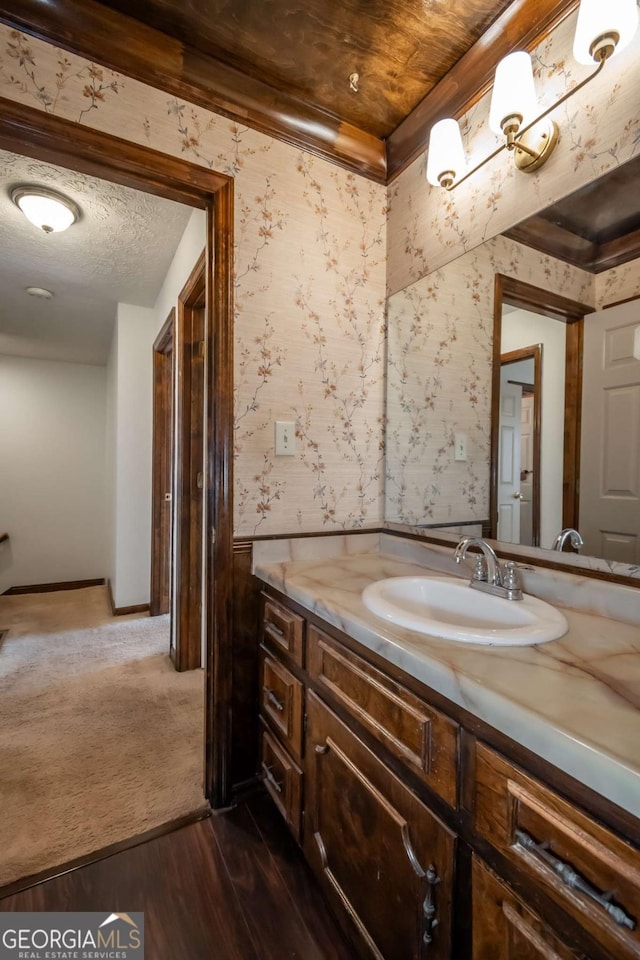 bathroom with vanity, wood-type flooring, and a textured ceiling