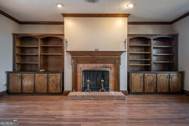 unfurnished living room featuring ornamental molding, dark hardwood / wood-style flooring, and a brick fireplace