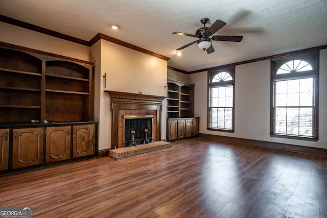 unfurnished living room with crown molding, a fireplace, and dark hardwood / wood-style floors