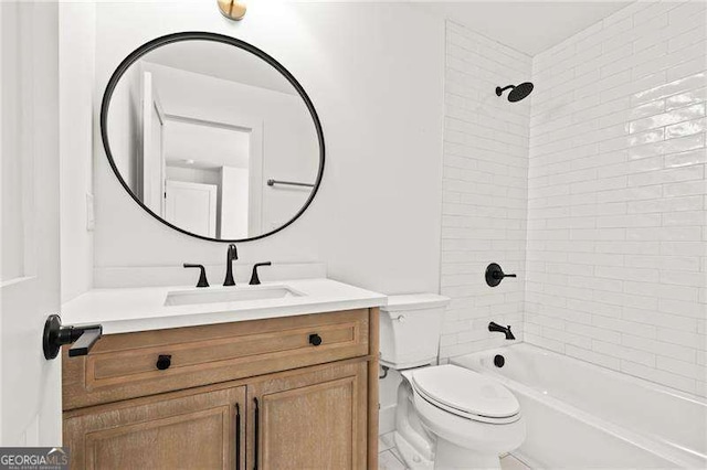 full bathroom featuring tiled shower / bath, vanity, and toilet