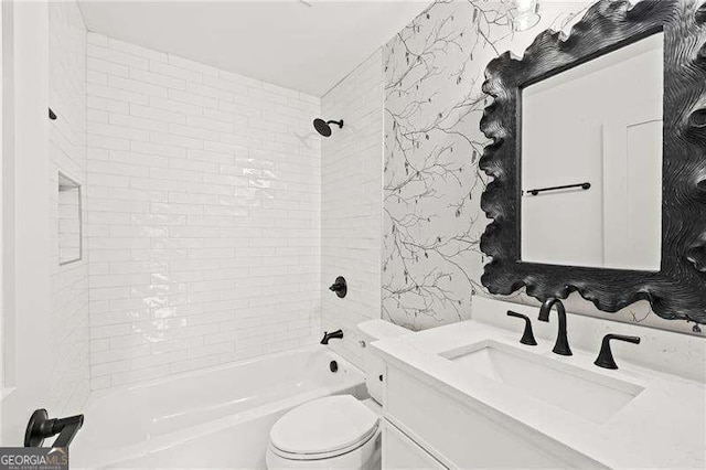 full bathroom with tiled shower / bath, vanity, and toilet