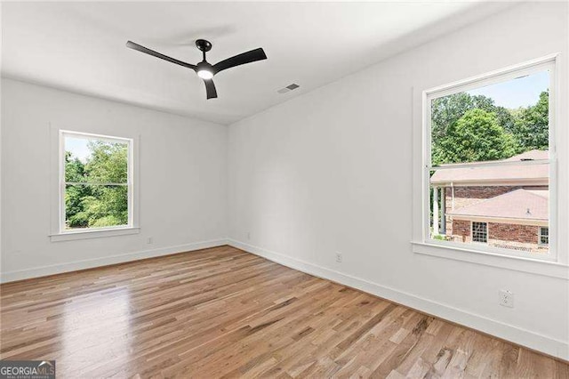 spare room with light hardwood / wood-style floors and ceiling fan