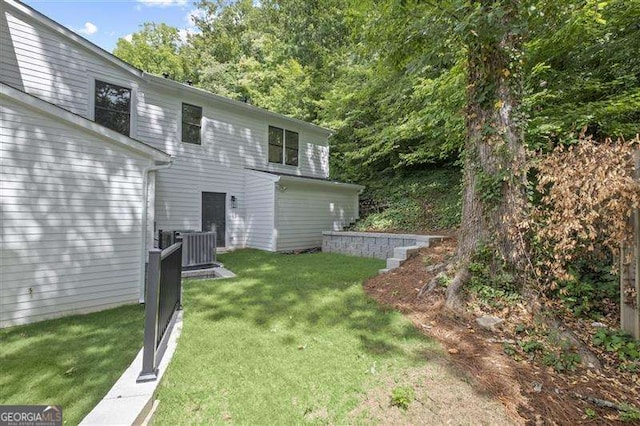 back of property featuring a yard and cooling unit