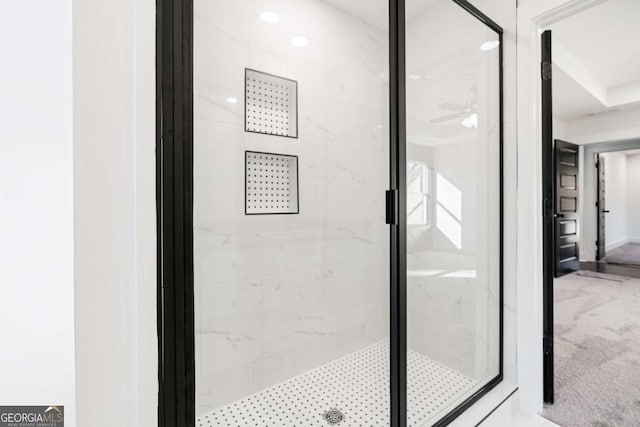 interior space with walk in shower, ceiling fan, and carpet