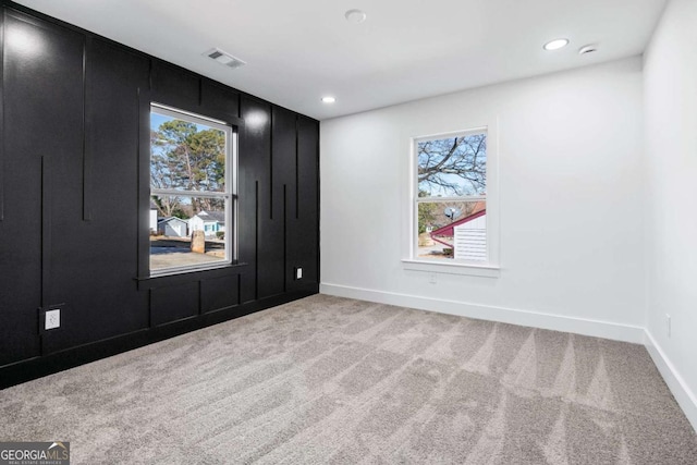 spare room with light colored carpet