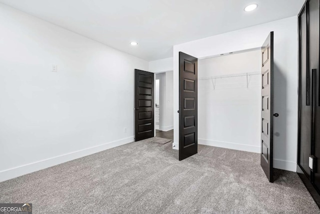 unfurnished bedroom featuring carpet flooring and a closet