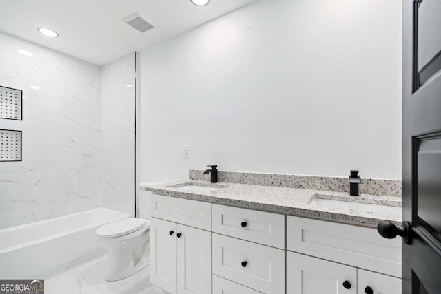 full bathroom with vanity, tiled shower / bath combo, and toilet