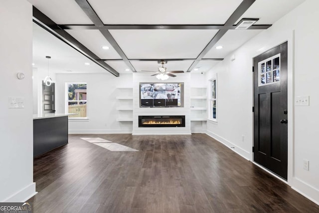 unfurnished living room with coffered ceiling, dark hardwood / wood-style floors, a large fireplace, and built in shelves