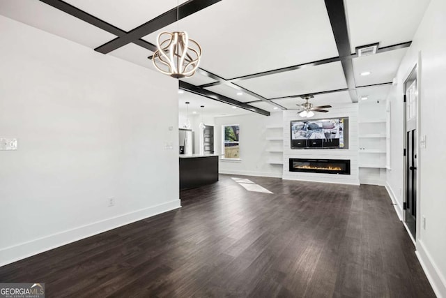 unfurnished living room featuring dark hardwood / wood-style floors, ceiling fan with notable chandelier, a fireplace, coffered ceiling, and built in shelves