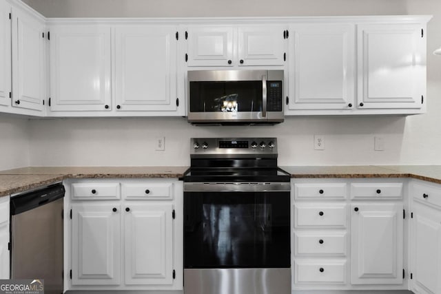 kitchen featuring appliances with stainless steel finishes, stone countertops, and white cabinets