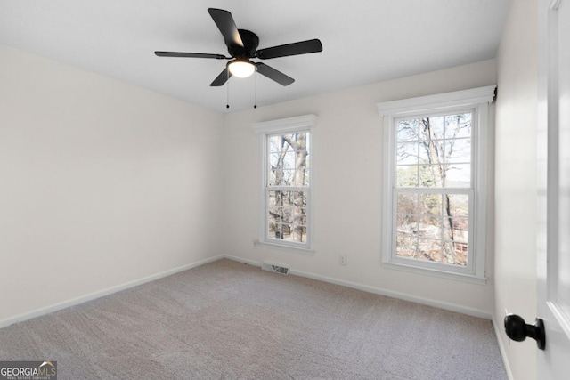 carpeted empty room featuring ceiling fan