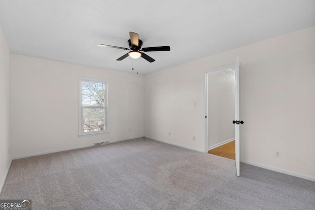 unfurnished room featuring light colored carpet and ceiling fan