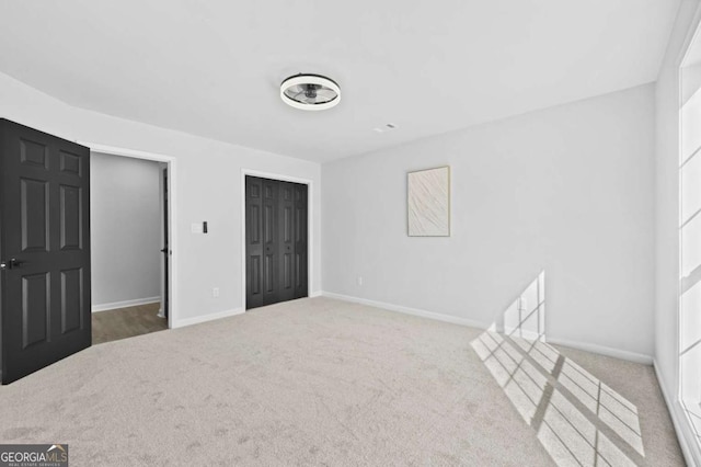 unfurnished bedroom featuring carpet floors and a closet