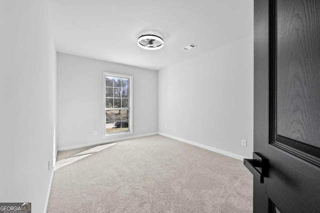 unfurnished room featuring carpet flooring