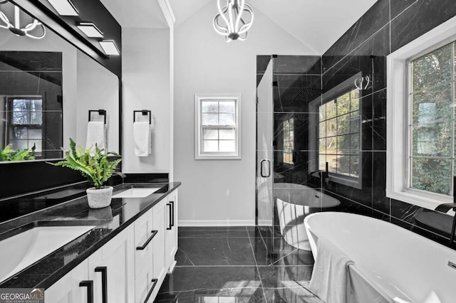 bathroom with vanity, shower with separate bathtub, and vaulted ceiling