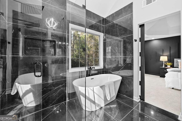 bathroom with tile walls, lofted ceiling, and separate shower and tub