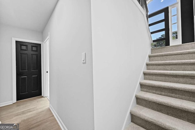 stairway featuring hardwood / wood-style floors