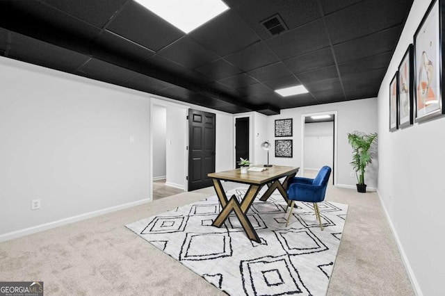 office area with a paneled ceiling and light colored carpet