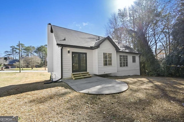 back of property featuring a lawn and a patio area