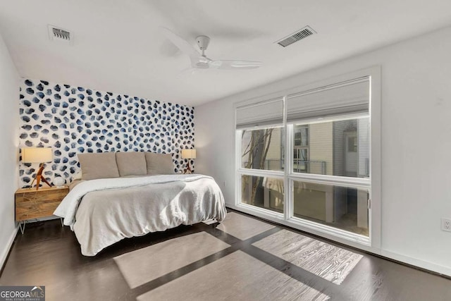 bedroom with dark hardwood / wood-style floors and ceiling fan