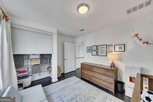 bedroom with dark hardwood / wood-style flooring