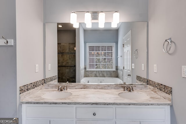 bathroom with vanity, backsplash, and a bathtub