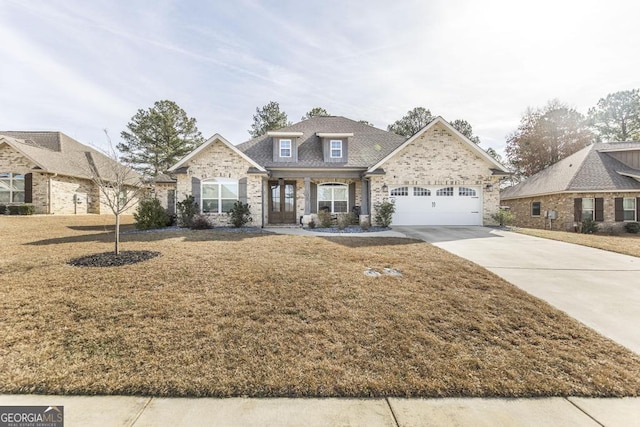 view of front of property with a garage and a front lawn