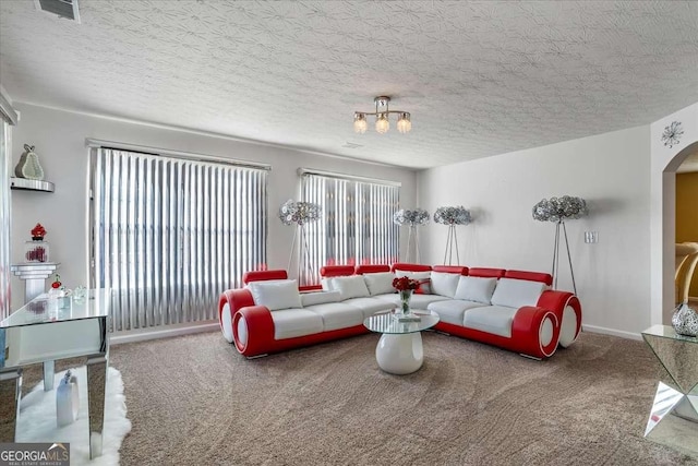 living room with carpet floors and a textured ceiling