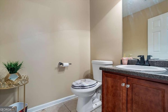 bathroom featuring tile patterned floors, toilet, and vanity