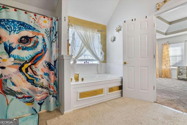 bathroom featuring lofted ceiling and a bathtub