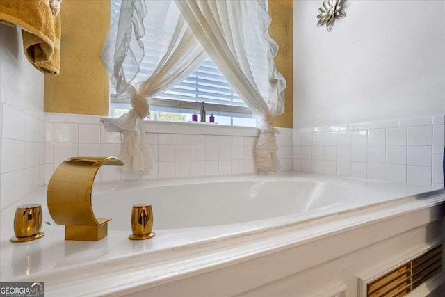 bathroom featuring a relaxing tiled tub