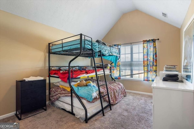 bedroom featuring lofted ceiling and carpet flooring