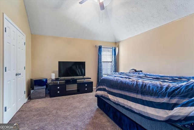 bedroom featuring lofted ceiling, ceiling fan, a textured ceiling, and carpet