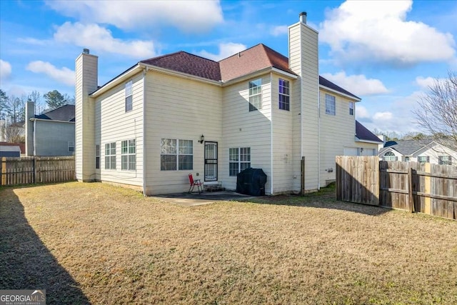 rear view of property featuring a patio and a lawn