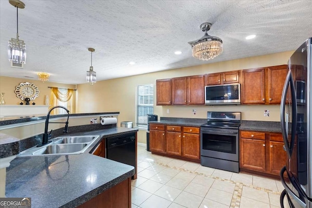 kitchen with stainless steel appliances, sink, light tile patterned floors, and decorative light fixtures