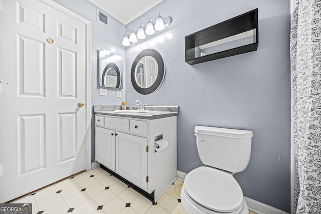 23 Chelsea Ct, Avondale Estates, GA 30002 - bathroom featuring toilet, vanity, visible vents, and baseboards