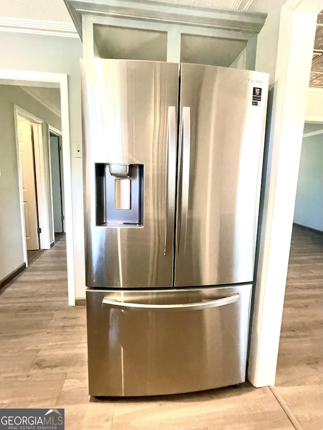 kitchen featuring stainless steel refrigerator with ice dispenser, crown molding, and light hardwood / wood-style flooring